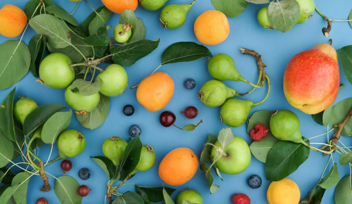 a bunch of fruit sitting on top of a blue surface