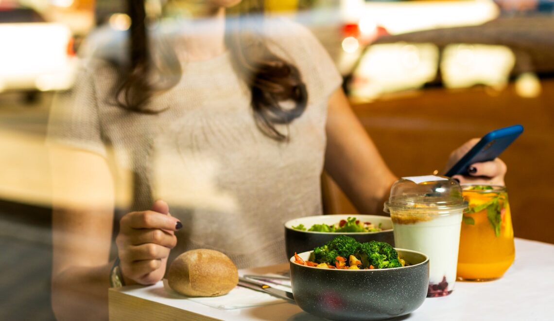 woman in white tank top holding spoon