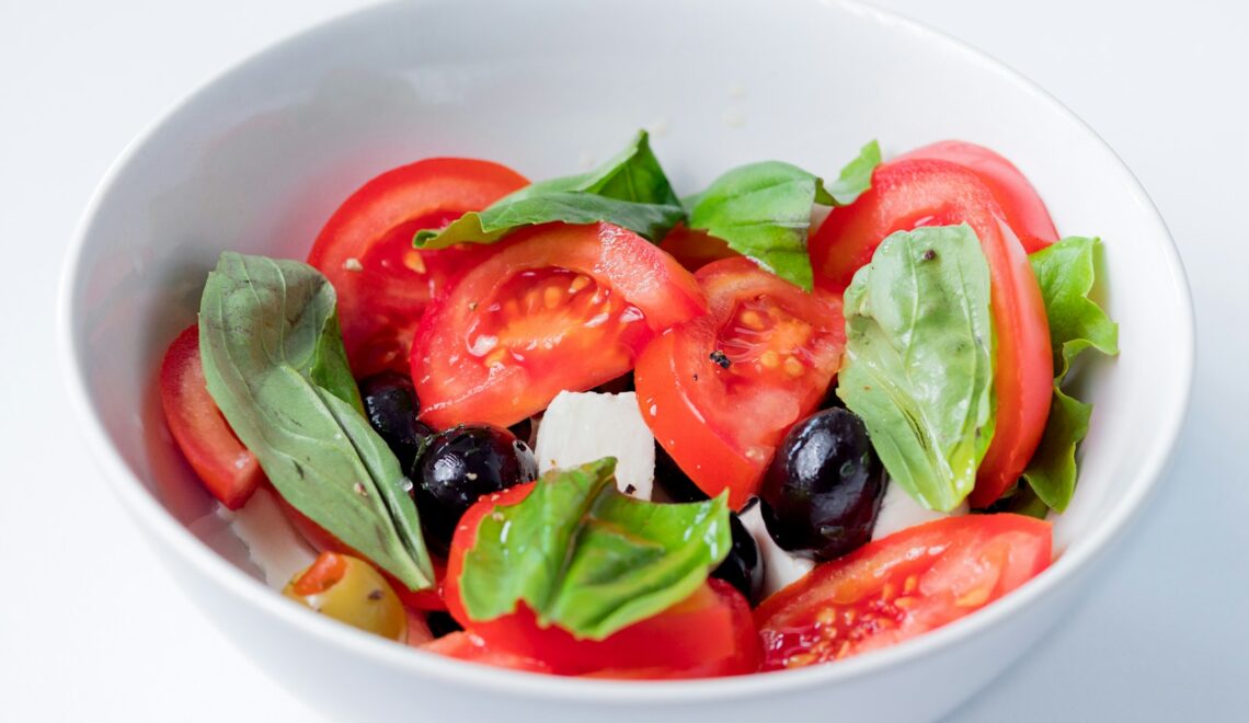 red and green bell pepper on white ceramic bowl