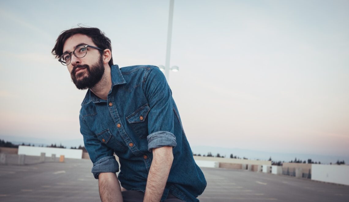 man wearing denim sport shirt and sunglasses on concrete flooring