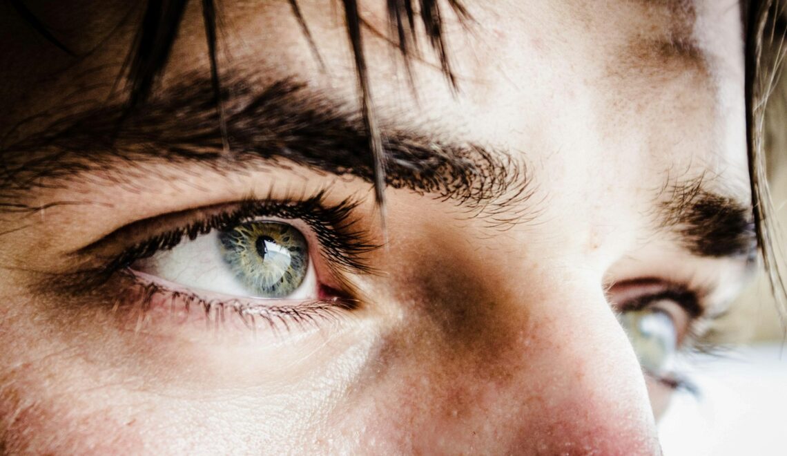 close up photo of gray-eyed man